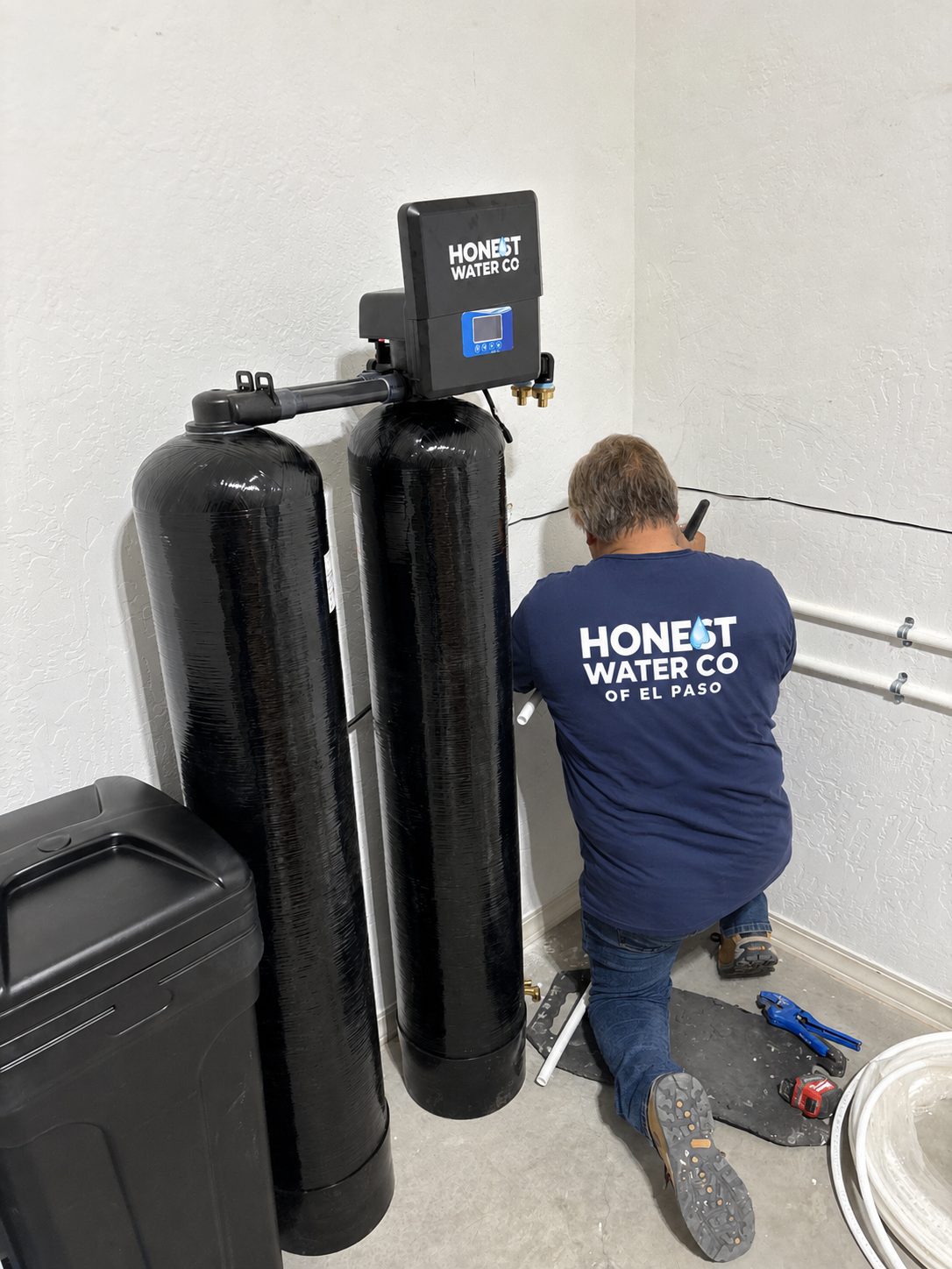 Honest Water Co install team fitting a whole-home softener in an El Paso garage